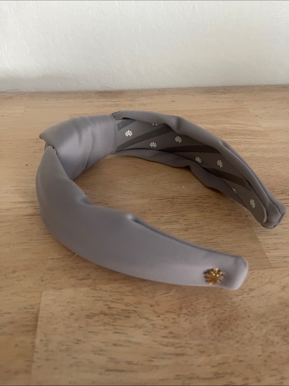 Lele Sadoughi Light Gray Padded Knot Headband with Gold Flower Accent